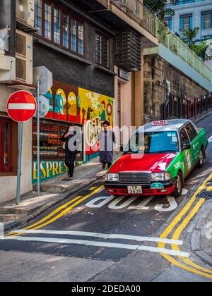 Hong Kong taxi Aberdeen Street une des rues escarpées de Hong Kong - Hong Kong taxi descend une colline escarpée dans le quartier central. Banque D'Images