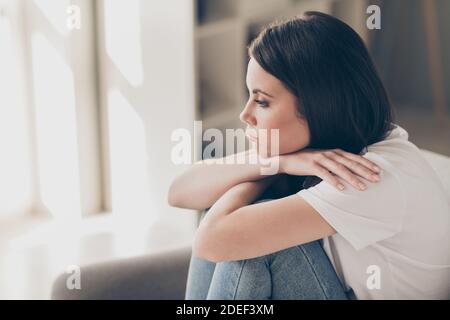 Profil photo de côté de la jeune fille attrayante problèmes quotidiens de pensée concept canapé assis dans la maison à l'intérieur Banque D'Images