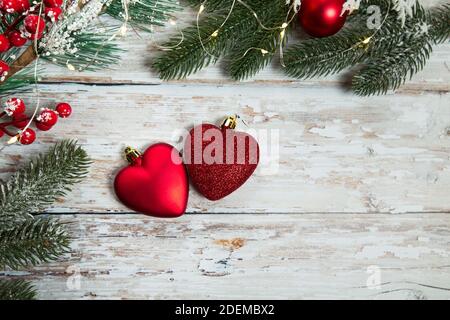 jouets rouges sous forme de coeurs sur fond de bois clair. plat de noël Banque D'Images