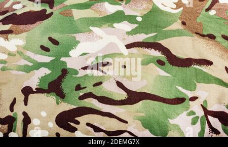 Photo d'un tissu de camouflage multicolore militaire texture gros plan. Banque D'Images