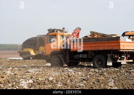 Tri des déchets dans la décharge de la grande ville. Beaucoup de déchets. Chariot avec manipulateur hydraulique manuel. Équipement lourd. Banque D'Images