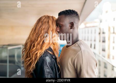 Photo d'un jeune couple multiethnique qui se serre. Banque D'Images