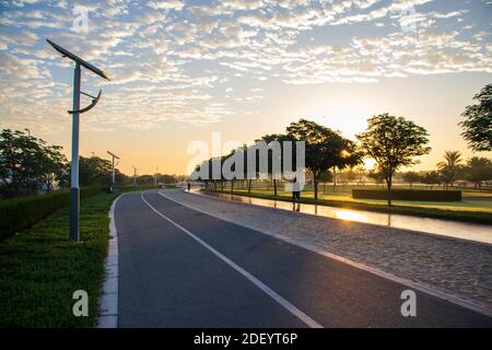 Pistes de jogging et de vélo dans le parc Al Warqa, Dubaï, Émirats arabes Unis tôt le matin. Le poteau de lampe alimenté par des panneaux solaires peut être vu dans l'image. À l'extérieur Banque D'Images