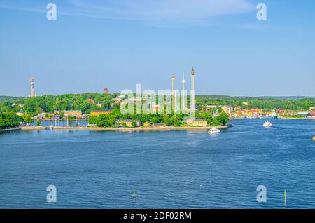 Vue panoramique aérienne de l'île de Djurgarden et des attractions du carrousel Tivoli Grona Lund Luna Park avec forêt verte et fond bleu ciel, L Banque D'Images