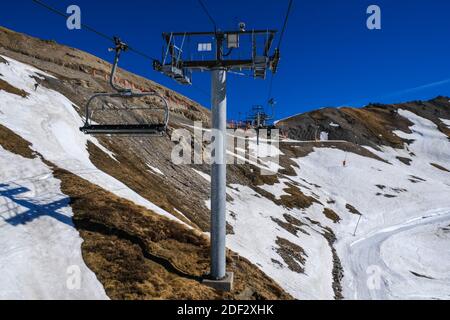 Télésiège dans la montagne et la neige. Au coeur des vacances scolaires d'hiver 2020, et en l'absence de neige depuis plus d'un mois, la plupart des stations de ski des Pyrénées ont du mal à attirer les touristes. À la Mongie (Hautes Pyrénées, France), près de la moitié du domaine skiable doit rester fermé ; des efforts quotidiens sont faits pour apporter la neige là où elle manque, grâce aux tondeuses à neige ou à la production de neige artificielle. Face aux signes du réchauffement climatique, les stations de ski prévoient de se tourner vers le tourisme de la saison 4. Photo de Patrick Batard / ABACAPRESS.com Banque D'Images