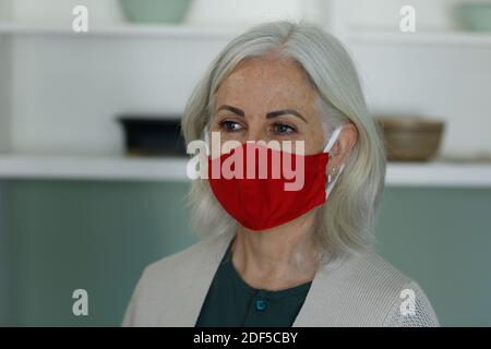 Femme caucasienne âgée portant un masque facial à la maison Banque D'Images