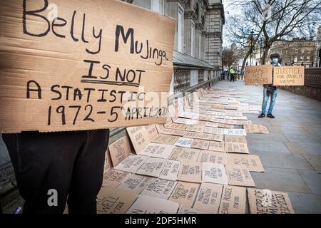 Le bénévole Trey Campbell-Simon détient une pancarte à la mémoire de l'ouvrier souterrain de Londres, Belly Mujinga. Des noms qui ne sont pas des chiffres protestent à Whithall. Le fondateur Ellis Tustin a commencé à afficher les noms de poeple qui sont morts de Covid 19 depuis le début de la pandémie. Après Ellis grand-père , Berrice Moore, est mort de Covid 19 il a décidé de se tenir à l'extérieur 10 Downing Street tenant une pancarte portant son nom, Afin de rappeler au Gouvernement leur responsabilité durant cette pandémie, la manifestation a augmenté, de nombreux membres du public envoyant pour eux des noms d'amis et de membres de leur famille Banque D'Images