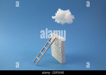 Échelle vers ciel bleu avec nuage blanc penche vers mur de brique blanche. Liberté, leadership, concept de réussite. Banque D'Images