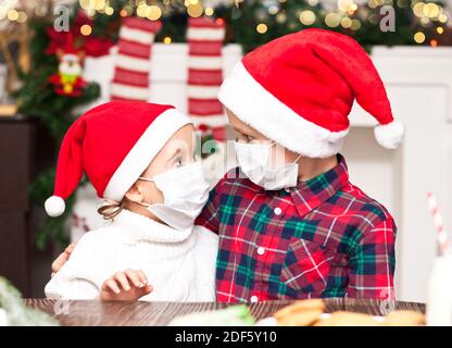 joyeux noël, enfant drôle avec masque médical dans un costume de