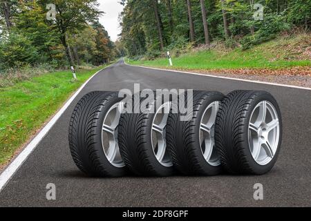 Jeu de roues de voiture - quatre roues de voiture disposées en un rangée sur la route asphaltée à côté de la forêt - Illustration 3D Banque D'Images