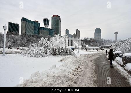 La promenade au bord de la rivière après les chutes de neige en hiver sur le côté canadien des chutes du Niagara. Les hauts hôtels et la tour Skylon sont visibles Banque D'Images