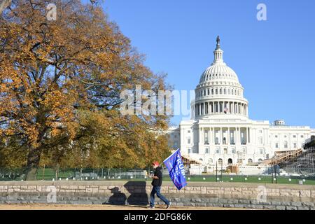 Washington DC. 14 novembre 2020. La marche de Mages. Un homme à la casquette rouge marchant avec le drapeau Trump 2020 devant le Capitole des États-Unis. Banque D'Images