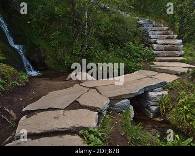 Pont de roche sur le sentier de randonnée en pierre construit par les Sherpas népalais menant au célèbre sommet de la montagne de Reinebringen, Moskenesøya, Lofoten. Banque D'Images