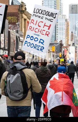 Anti-lockdown protesters in Toronto speak out about the effect COVID-19 lockdowns have on different demographics. Stock Photo