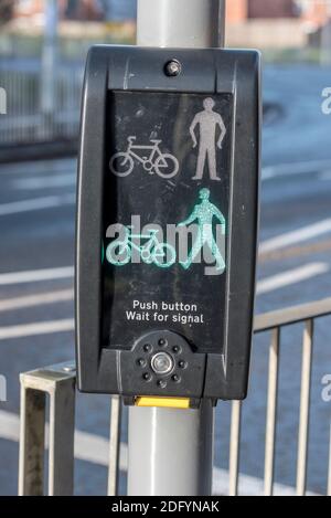 Commande par bouton-poussoir des feux de circulation pour piétons. Le panneau vert indique OK pour traverser. Banque D'Images