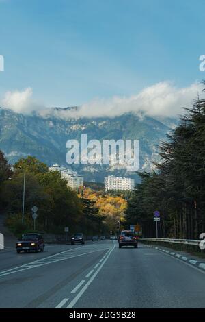 Route vers Yalta avec vue sur les montagnes et les nuages le 29 novembre 2020. Voyagez le long de la côte sud de la Crimée. Paysage urbain d'automne. Nuages bas f Banque D'Images