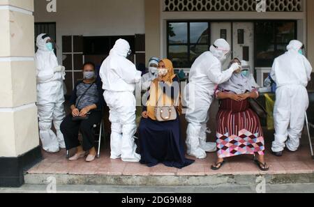 Surabaya, Indonésie. 8 décembre 2020. Les travailleurs médicaux portant des combinaisons de protection prélèvent des échantillons d'écouvillons de femmes enceintes pour le test COVID-19 à Surabaya, Indonésie, le 8 décembre 2020. Credit: Kurniawan/Xinhua/Alay Live News Banque D'Images