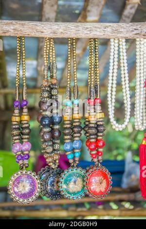 Perles tribales colorées et colliers souvenir à vendre dans la rue au marché local, Chiang Rai, Thaïlande. Banque D'Images