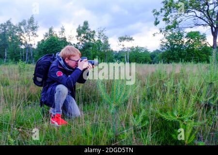 Jeune photographe prenant des photos Banque D'Images