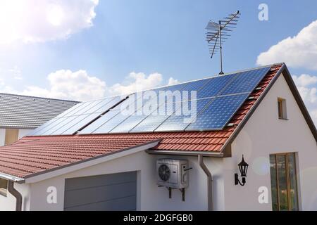 Panneaux solaires sur le toit de la maison 3d rendring Banque D'Images