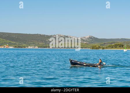 Vue sur l'île de Pašman, voilier dans un petit bateau à moteur, depuis la côte dalmate, Croatie, au bord de la mer Adriatique. Banque D'Images