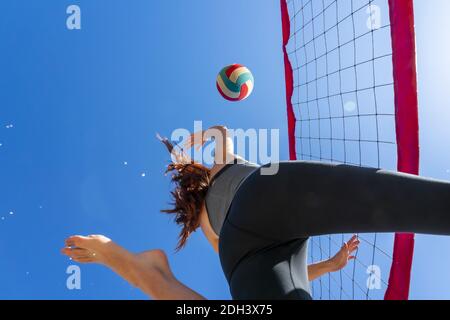 Un magnifique modèle de forme physique Redhead se préparant à jouer au volley-ball Banque D'Images