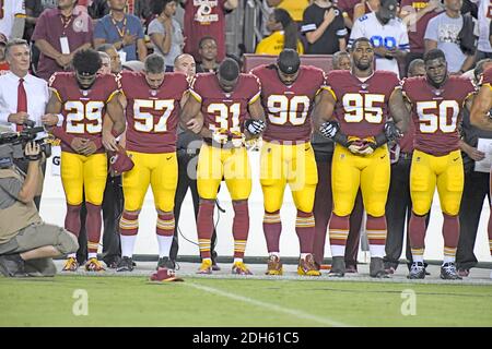Redskins de Washington le président de l'équipe Bruce Allen, extrême gauche, bras serrures en solidarité avec les joueurs, de gauche à droite, Kendall évoluait Fuller (29), long snapper Nick Sundberg (57), Fabian évoluait Moreau (31), le nez s'attaquer à Ziggy Hood (90), défensive fin Jonathan Allen (95), et à l'extérieur de secondeur Martrell Spaight (50) comme l'hymne national est chanté avant le match contre les Raiders d'Oakland au FedEx Field à Landover, Maryland le dimanche, 24 Septembre, 2017. Les Redskins ont choisi de démontrer avant leur concours télévisé à l'tweets suivants plus tôt dans la journée à partir de United States Banque D'Images