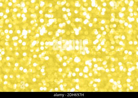 Moderne magnifique fond holographique des lumières de vacances bokeh dans la couleur jaune tendance. Concept Color 2021. Papier peint. Banque D'Images