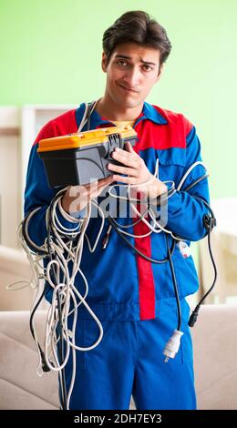 Entrepreneur électricien avec les câbles emmêlés Banque D'Images