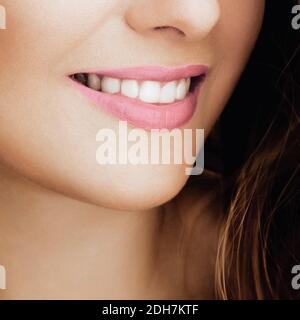 Belle femme en bonne santé sourire avec des dents blanches naturelles parfaites, beauté visage gros plan de la jeune femme souriante, rouge à lèvres brillant mak Banque D'Images