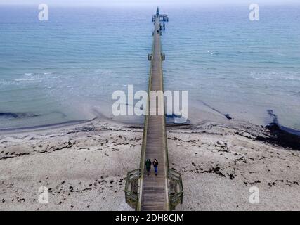 Boltenhagen, Allemagne. 10 décembre 2020. Deux femmes marchent dans le brouillard sur la jetée. (Vue aérienne avec un drone) en raison du verrouillage partiel de la couronne, les hôtels, les restaurants et les installations touristiques sur la côte de la mer Baltique dans le Mecklembourg-Poméranie occidentale sont fermés. Credit: Jens Büttner/dpa-Zentralbild/dpa/Alay Live News Banque D'Images