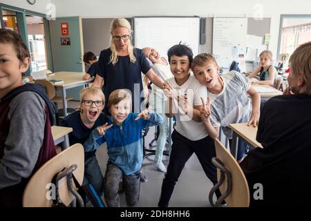 Des élèves joyeux avec un professeur en classe Banque D'Images