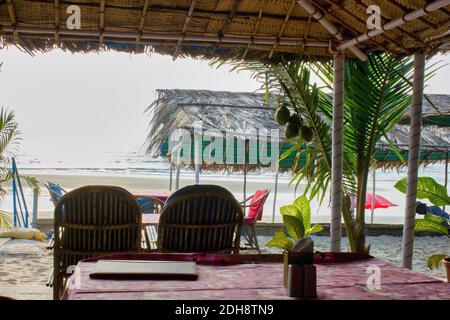 Une vue d'un client dans un restaurant situé sur une plage à Goa, Inde | intérieur vide d'un restaurant contre la mer arabe. Banque D'Images