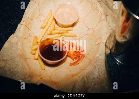 Vue en grand angle des frites avec sauce à la table dans le café Banque D'Images