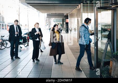 Les gens se tenant en file d'attente devant le café Banque D'Images