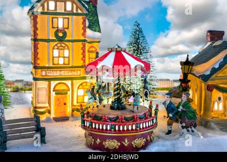 Un village de Noël miniature avec un carrousel et des boutiques. Banque D'Images