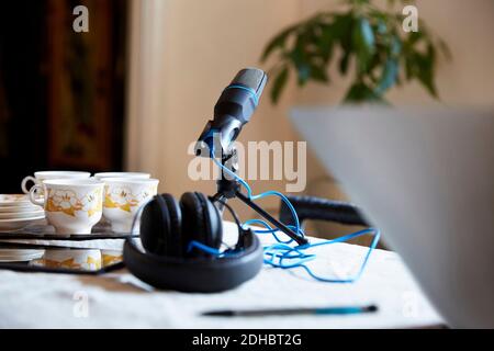 Gros plan du microphone et du casque avec vaisselle sur la table à accueil Banque D'Images