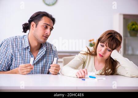 Jeune couple dans le concept inattendu de grossesse à la maison Banque D'Images