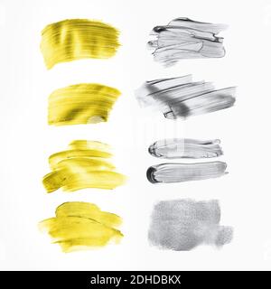 Ensemble de touches de peinture dorées et grises pour votre conception. Isolé sur fond blanc. Chaque élément peut également être utilisé comme arrière-plan pour le texte. Banque D'Images