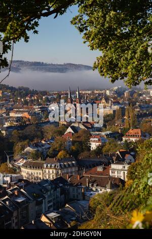 Freiburg im Breisgau, Germany - 11 09 2012: Scenic view to the city and St. Johann church from the mountain, snow-covered Black forest Stock Photo