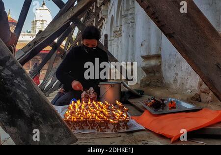 Katmandou, Bagmati, Népal. 11 décembre 2020. Le 11 décembre 2020, une femme brûle des lampes au beurre en offrant des prières pendant Guhyeshwari yatra à la place Hanumanchoka Durbar à Katmandou, au Népal. Guhyeshwari Yatra est un festival, qui est une visite qui commence à porter palanquin composé d'idoles de Guhyeshwari après le temple de Pashupatinath et se termine à la place Hanuman Dhoka Durbar. Crédit : Sunil Sharma/ZUMA Wire/Alay Live News Banque D'Images