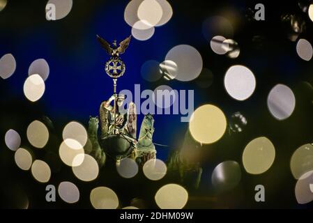 Berlin, Berlin, Allemagne. 11 décembre 2020. La Quadriga illuminée de la porte de Brandebourg est visible derrière des guirlandes de lumières floues sur un arbre de Noël sur Pariser Platz. Crédit : Jan Scheunert/ZUMA Wire/Alay Live News Banque D'Images