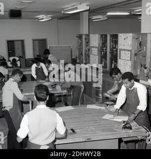 Années 1960, jeune arabe historique dans une classe dans un collège technique, Jeddah, Arabie Saoudite, l'apprentissage du travail du bois et des compétences de menuiserie. Une affiche, en anglais, décrivant l'outil Stanley Block plane, est visible sur le mur, que l'un des étudiants utilise. Banque D'Images