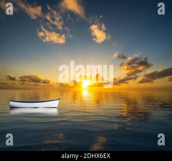 Bateau à rames blanc sans dérive sur la mer vers un coucher de soleil pour illustrer la crise du leadership Banque D'Images