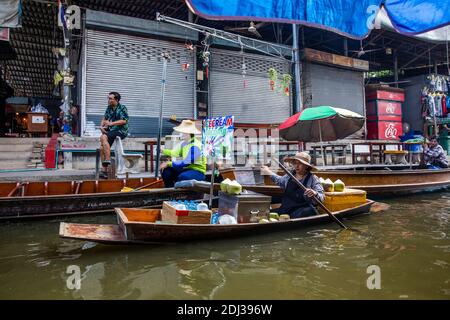 Les marchands de lait de noix de coco font une pause en attendant les clients sur le marché flottant de Damneon près de Bangkok, en Thaïlande. Banque D'Images