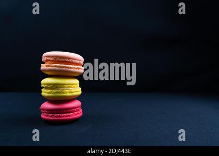 Colourful stack of macaroons isolated on plain black background, Copyspace Stock Photo