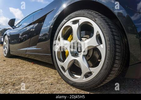Close up detail of the rear wheel and arch on a metallic black first generation Lamborghini Gallardo V10 sports car outside in sunshine Stock Photo