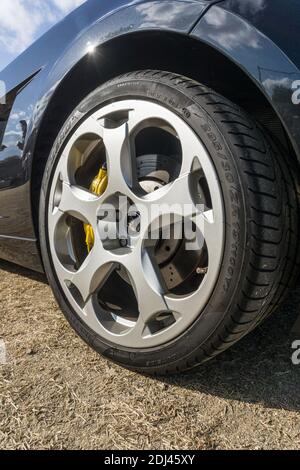 Close up detail of the rear wheel and arch on a metallic black first generation Lamborghini Gallardo V10 sports car outside in sunshine Stock Photo