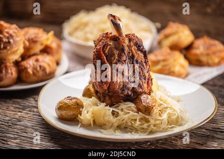 Jarret de porc bavarois avec choucroute et pommes de terre cuites au four. Banque D'Images