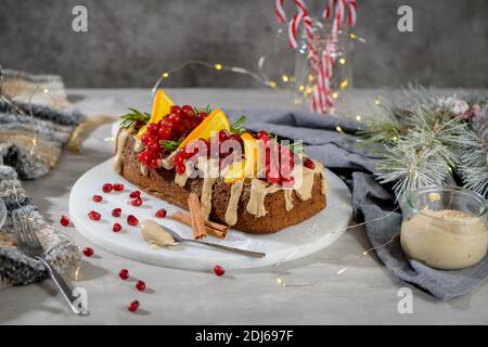Gâteau de Noël à la cannelle fait maison avec des fruits et des biscuits au spekulatius crème sur un comptoir de cuisine. Banque D'Images